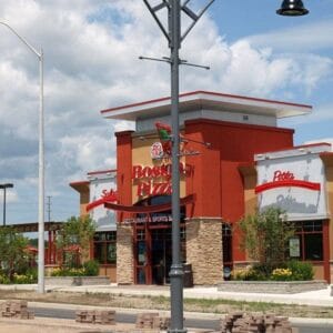 K829 Aurora Sr. fixtures accompanied by London style arms and banner arms on top of a Canterbury jr. metal pole.