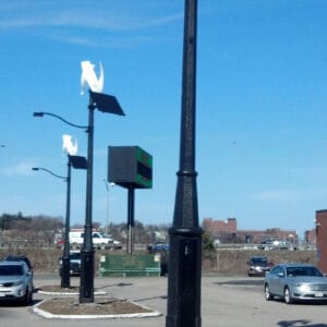 Solar panels and fixtures on top of an Alexander pole.