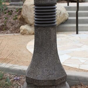 Multiple lit Belmont style bollards finished with one of our signature concrete décor colors – Midnight Lace.