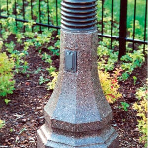 A lit Belmont style bollard finished with one of our signature concrete décor colors - Saluki Bronze.