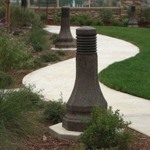 Multiple lit Belmont style bollards finished with one of our signature concrete décor colors - Midnight Lace.