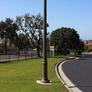 A K807 Doral Sr. fixture accompanied by a Bishop Crook with decorative scroll style arm on top of a Canterbury pole.
