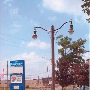 K205 Marquis fixtures accompanied by mini scroll style arms on a Belmont pole.