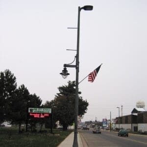 K366 Harbor Side (Pendant) - Kensington A K366 Harbor Side fixture accompanied by a Marina style arm, banner arms, and a flag mount all on a Kensington pole. Project is in Pine City, Minnesota.