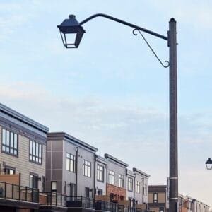 A K601D Coach Lantern fixture accompanied by Coach Lantern style arms on top of a Hexagonal Tapered pole. This project is in Grimsby, Ontario.
