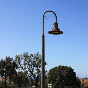 A K707 Doral Jr. fixture accompanied by a Bishop's Crook with decorative scroll arm on top of a Canterbury pole.