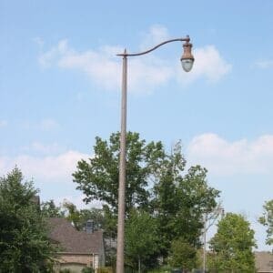 A K804 Coronet Sr. fixture accompanied by a pipe style arm on a Round Tapered pole.