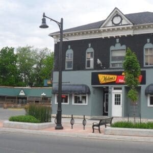 K820 Midland Sr. - Canterbury - 2 - Port Colborne, Ontario A K820 Midland Sr. fixture accompanied by banner arms and a Brookville style arm all on a Canterbury pole. This project is in Port Colborne, Ontario in front of Melina's Family Restaurant.