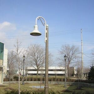 A K828 Moderne Sr. fixture accompanied by a Bishop Crook with decorative scroll arm all on a Canterbury pole.