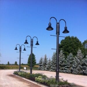K828 Moderne Sr. fixtures accompanied by banner arms and Bishop Crook style arms all on a Canterbury pole.