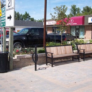 A KDB Trafalgar Bench made from oak material and finished in one of our signature powder coat solutions. This project is outside of a shopping center in Kincardine, Ontario.
