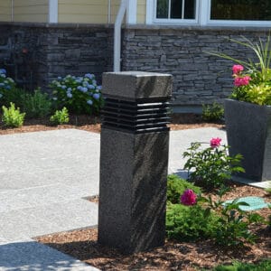 A lit Martello Square style bollard finished with one of our signature concrete décor colors - Pearl Gray.