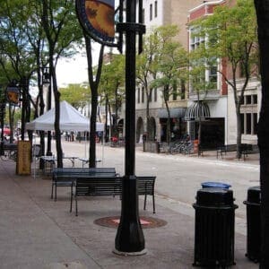 A K803 Solitaire Sr. fixture accompanied by a low-rise styled arm and banner arms all on a Memphis pole. This project is in Madison, Wisconsin.