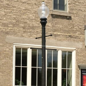 A K118 Washington fixture accompanied by banner arms on a Memphis pole. This project is outside the Town Hall 1873 Theatre in Port Perry, Ontario.