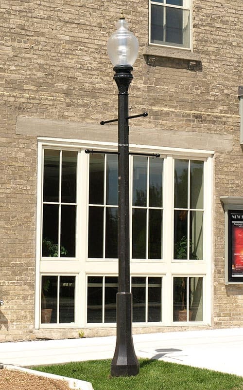 A K118 Washington fixture accompanied by banner arms on a Memphis pole. This project is outside the Town Hall 1873 Theatre in Port Perry, Ontario.