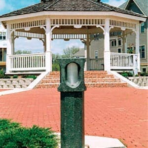Monitor Bollard - Concrete - Waunakee, Wisconsin A lit Monitor style bollard finished with one of our signature concrete décor colors – Aztec Jade. This project is in Savannah Village, a neighborhood in Waunakee, Wisconsin.