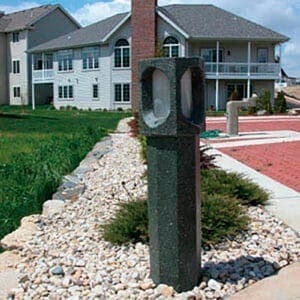 Monitor Bollard - Concrete - Waunakee, Wisconsin Multiple lit Monitor style bollards finished with one of our signature concrete décor colors - Aztec Jade. This project is in Savannah Village, a neighborhood in Waunakee, Wisconsin.