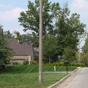 A K804 Coronet Sr. fixture accompanied by a pipe style arm on top of a Round Tapered pole.