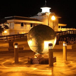 Multiple lit Silhouette style bollards finished with one of our signature concrete décor colors - Salt and Pepper. This project is located at Newport Beach Pier in Newport Beach, California.