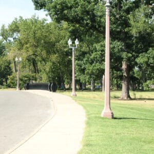 K424 Traditional acorn fixtures accompanied by light bracket arms all on top of a St. Louis pole.