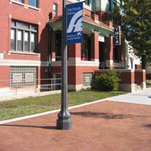A K118 Washington fixture accompanied by banner arms on Talisman style pole. This project is outside of the YMCA in Atchison, Kansas.