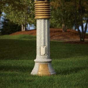Traditional Bollard - Concrete A lit Traditional style bollard finished with gold accents and one of our signature concrete décor colors - Pearl Gray.