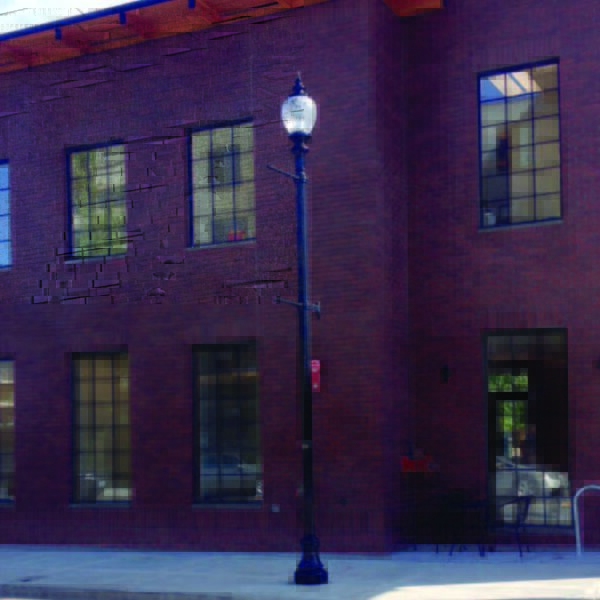A K118 Washington fixture accompanied by banners arms atop a metal pole. This project is in Gresham, Oregon.