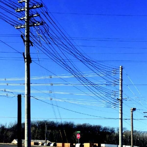 Image shows a few of StressCrete pre-stressed spun concrete poles installed to Kansas City's electrical system. With Kansas City's Board of Public Utilities continuously seeking ways to improve upon their electrical system, the BPU decided to upgrade their system with StressCrete's pre-stressed concrete poles due to their long service life, no maintenance, and lifetime warranty.