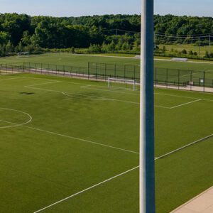 A Spartan sports lighting pole overlooking a soccer field. All poles are made from concrete materials, providing a reliable solution for all sport fields and facilities.