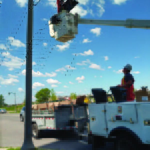 Utility workers installing one of the many K601D Coach Lantern pendant fixtures in Oakville, Ontario.