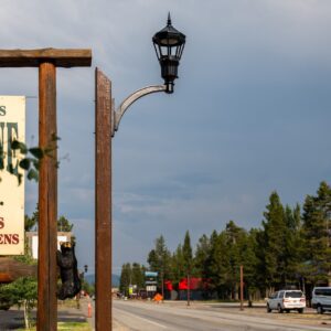A K54 Cleveland Jr. (no globe) accompanied by a custom-made arm on top of a Square Non-Tapered (Wood Grain) pole. This project is on one of the busy streets of West Yellowstone, Montana.