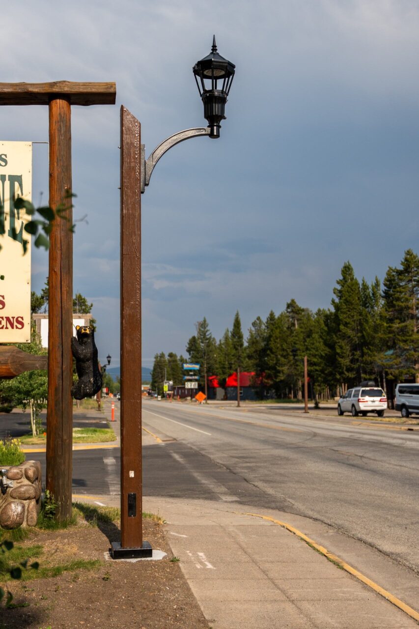 A K54 Cleveland Jr. (no globe) accompanied by a custom-made arm on top of a Square Non-Tapered (Wood Grain) pole. This project is on one of the busy streets of West Yellowstone, Montana.