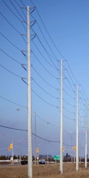 Utility Pole - Road Crossing A spun concrete utility pole with a 'road crossing' application. This project is next to a busy street.