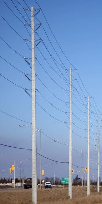 Utility Pole - Road Crossing A spun concrete utility pole with a 'road crossing' application. This project is next to a busy street.