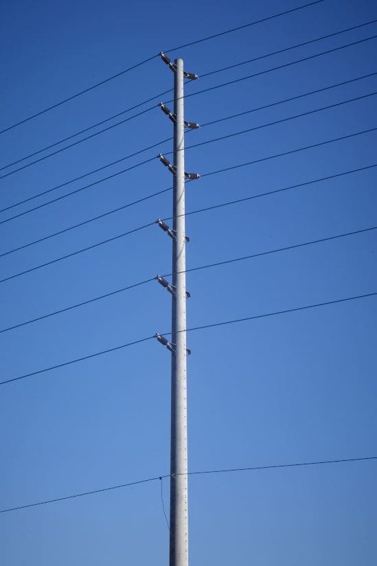 A spun concrete utility pole with a 'road crossing' application.