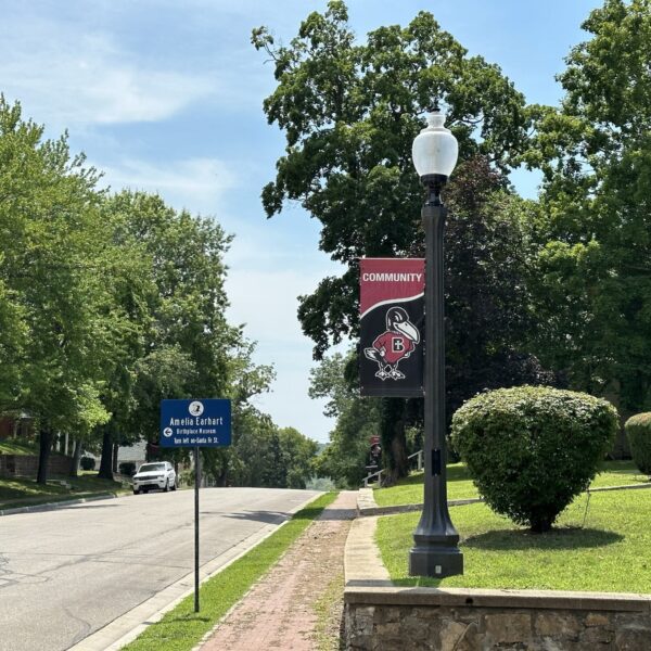 A K118 Washington accompanied by banner arms atop of a Belmont pole. This project is in a neighborhood located in Atchison, Kansas.