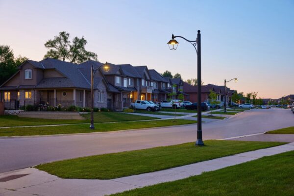 A K601D Coach Lantern fixture accompanied by a KA30 Scroll Arm with Decorative Scroll atop a Memphis pole. This project is in a neighborhood located in Smithville, Ontario.