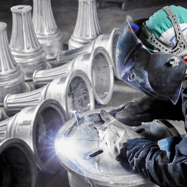 An employee at King Cast fabricating multiple King split bases.