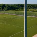 A Spartan sports lighting pole overlooking a soccer field. All poles are made from concrete materials, providing a reliable solution for all sport fields and facilities.