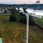 KSL1 STRATOS fixtures accompanied by a cross arm atop of a sports lighting pole. This project is at Shelton State Community College's softball diamonds in Tuscaloosa, Alabama.